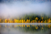 mist and fog over a lake in autumn 