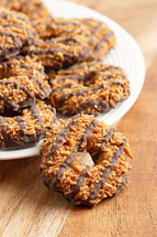 Coconut Caramel Fudge Striped Cookies on a Wood Kitchen Table