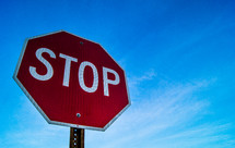 stop sign against a blue sky