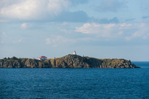 lighthouse on cliffs along a shore 