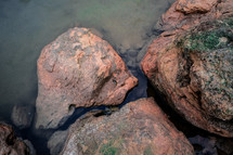 red rocks along a lake shore 