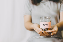 person holding a give jar 