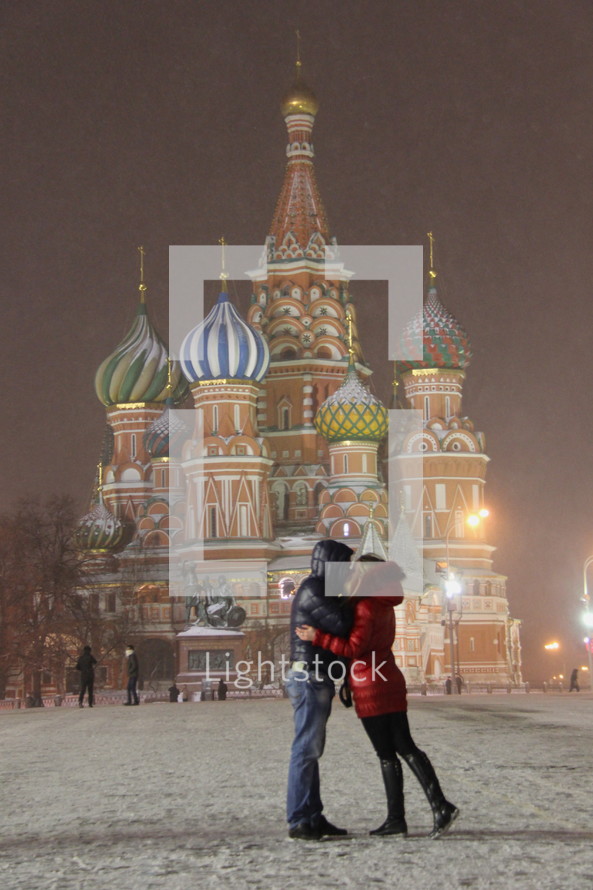 Couple kissing in front of St, Basils Cathedral, Moscow, Russia