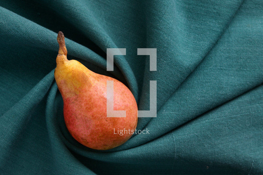 Pear on turquoise cloth
