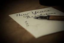 New Years resolution list and pen on a table.