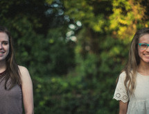 teen girls standing outdoors in summer 