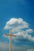 wood cross against a blue sky 