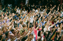 raised hands in worship at a conference 