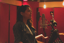 woman singing in a studio 