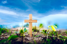 cross in the ground and blue sky in the background 