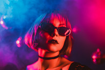 Portrait of young pretty woman in neon light. Pussy cat costume for halloween party. Sexy elegant lady with sunglasses and lace ears. High quality