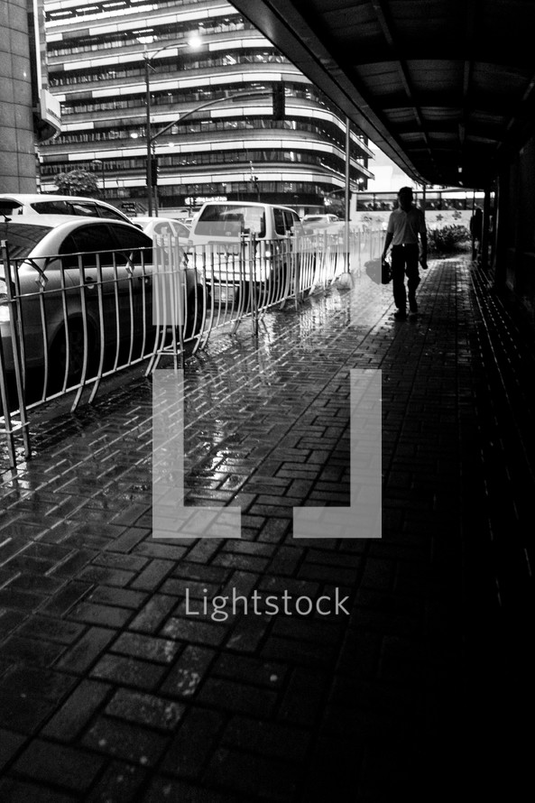 walking on a covered sidewalk in the rain 