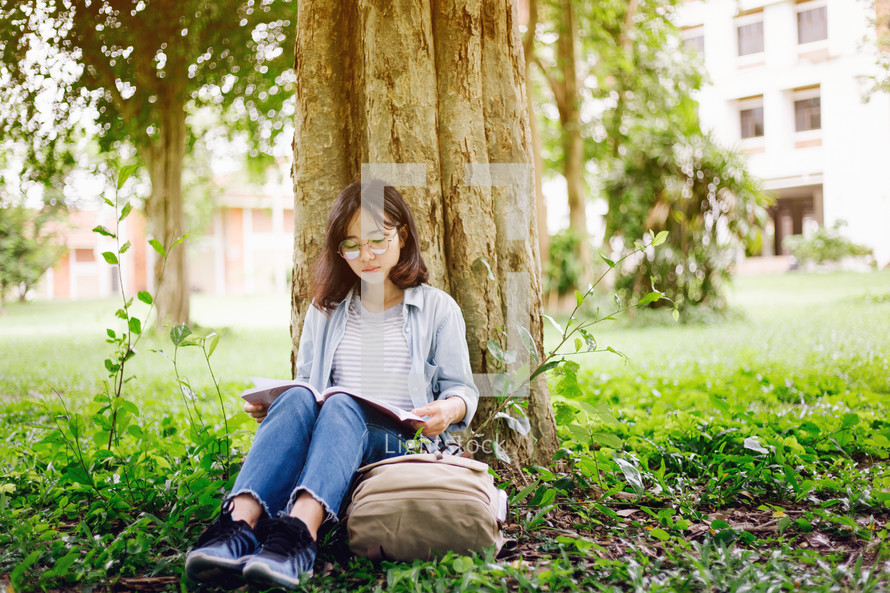 a girl studying in a park 