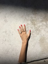 woman's hand, rings, and painted nails 