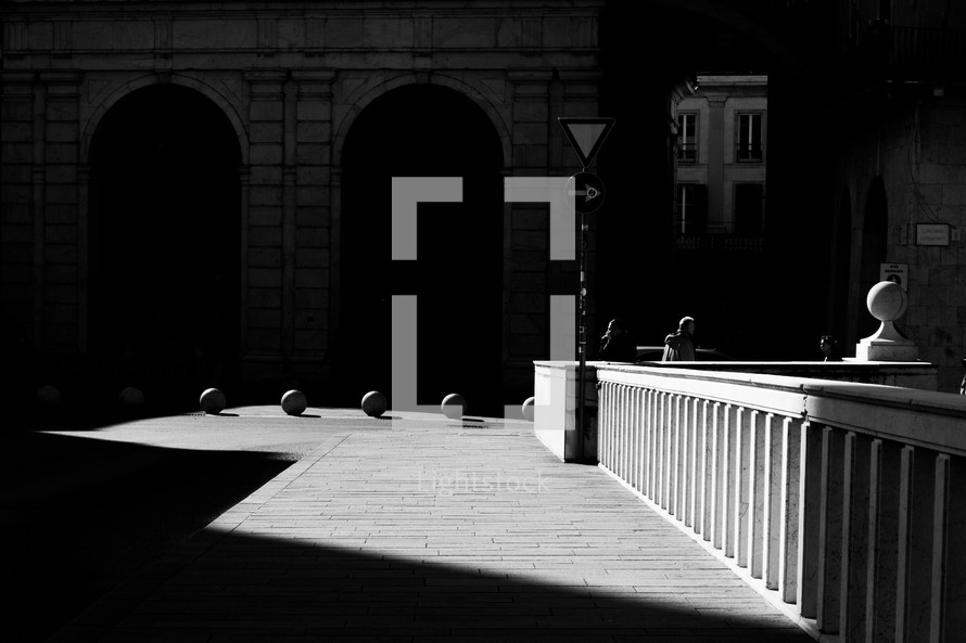 sunlight and shadows on a cobblestone street 