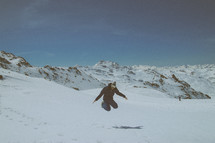 a man jumping in snow 