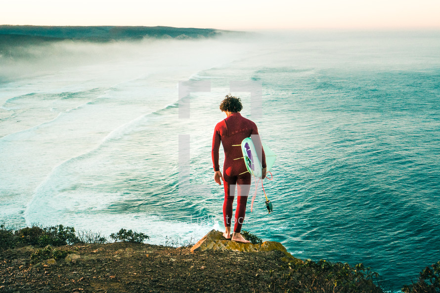 surfer standing on a beach 