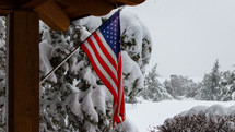 The flag of the United Staes with a winter background. 