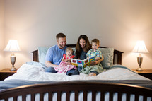 family reading together in bed 