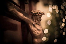 crucifix and bokeh Christmas lights 