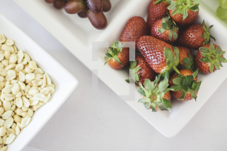 strawberries, oats, and grapes in a tray 