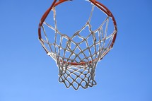 outdoor basketball hoop against blue sky 