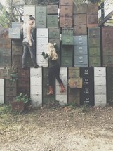 women climbing on old filing cabinets 