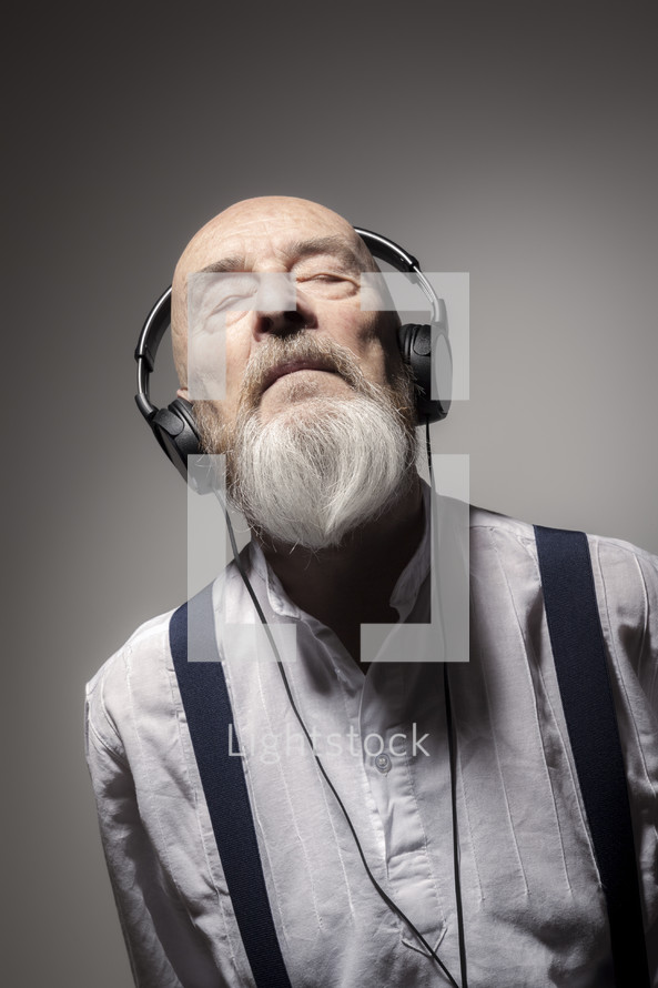 elderly man listening to headphones 