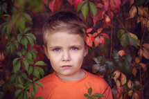 headshot of a boy in vines 