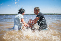 a child's baptism in water outdoors 