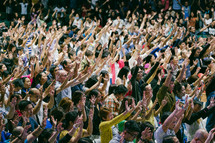 raised hands in worship at a conference 
