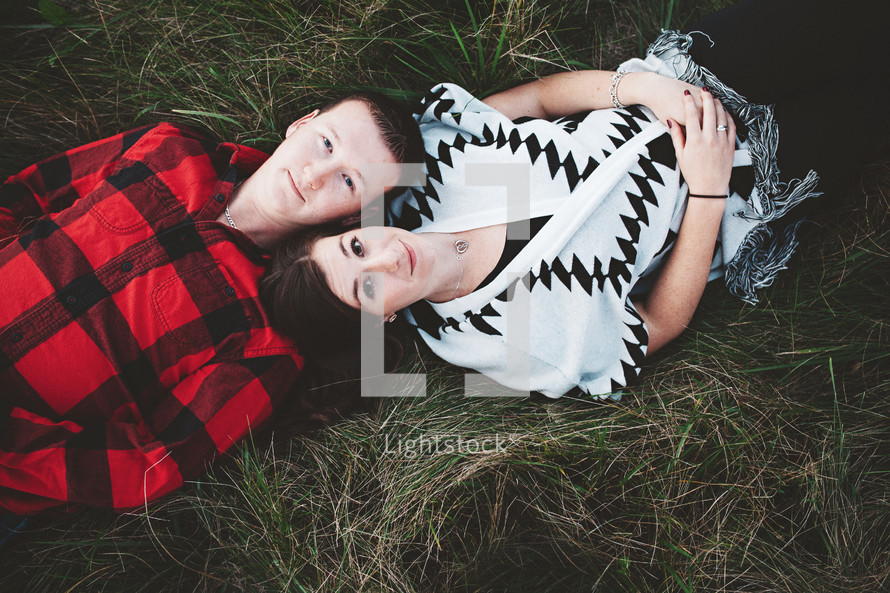 a couple lying in the grass