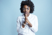 young African American female model posing with praying hands 