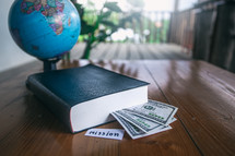 globe, Bible, and cash with word mission 