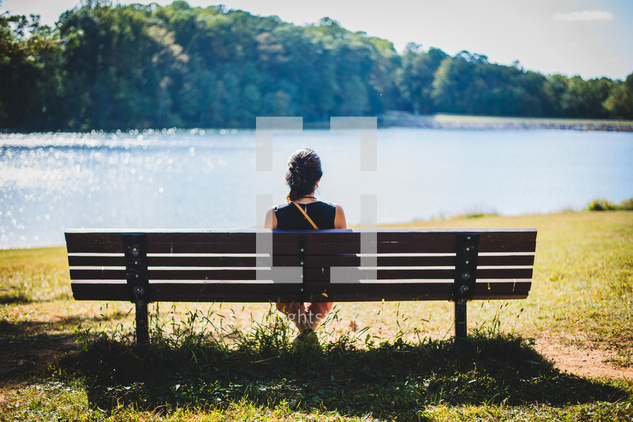woman sitting on a park bench 