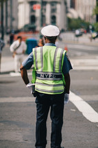 NYC police office directing traffic 