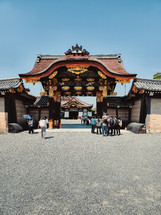 Tourist Entering The Gates Of A Temple 