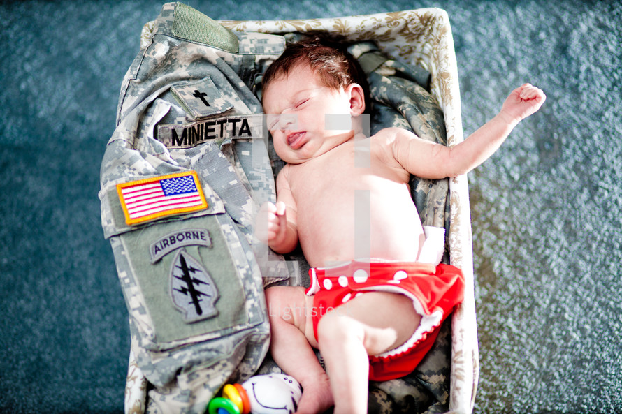 baby sleeping on military fatigues. 

Baby Dedication.