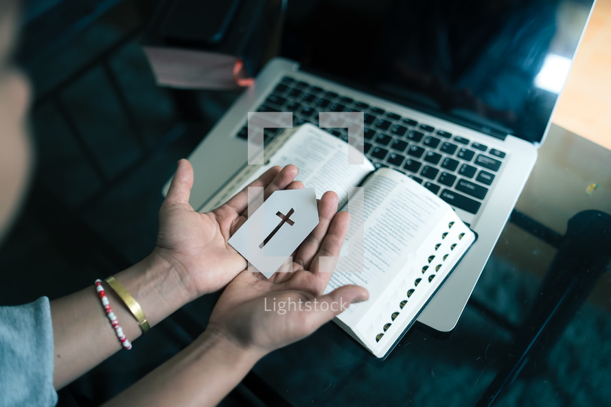 Woman holding paper church icon with computer laptop, Church services online concept, Online church at home concept.