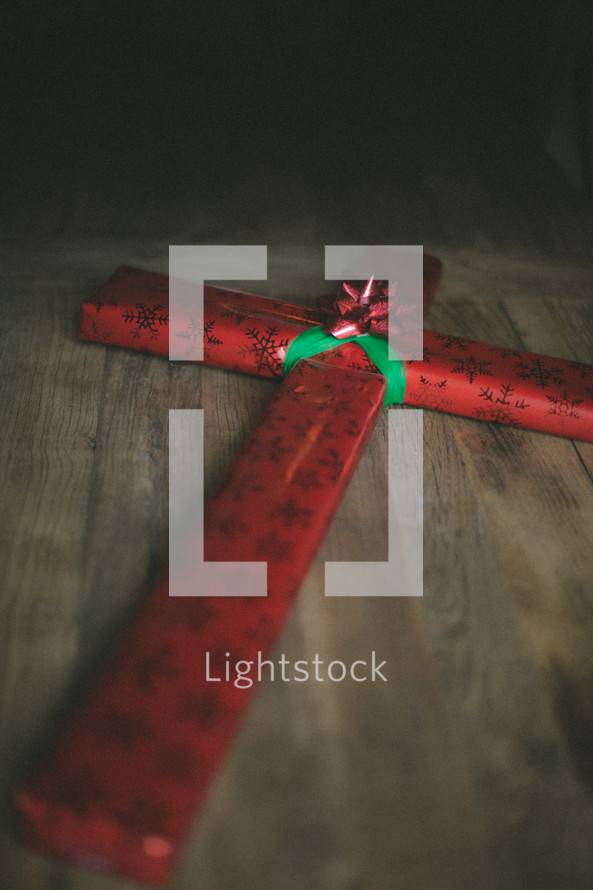cross wrapped in Christmas wrapping paper 