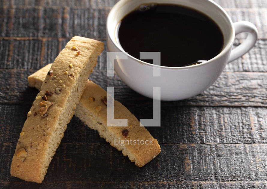 coffee and Almond and Walnut Biscotti Isolated on a Wood Background