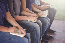 Young Teenages Studying the Bible Outside