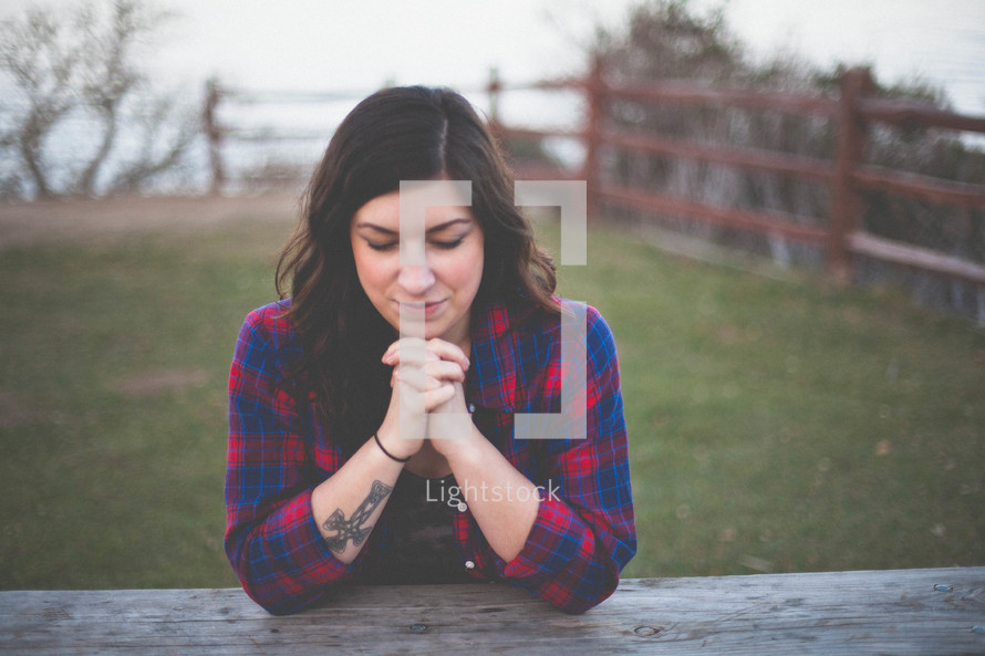 A woman praying outdoors 