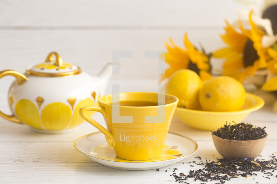 Bright Yellow Tea Set on a White Wood Table