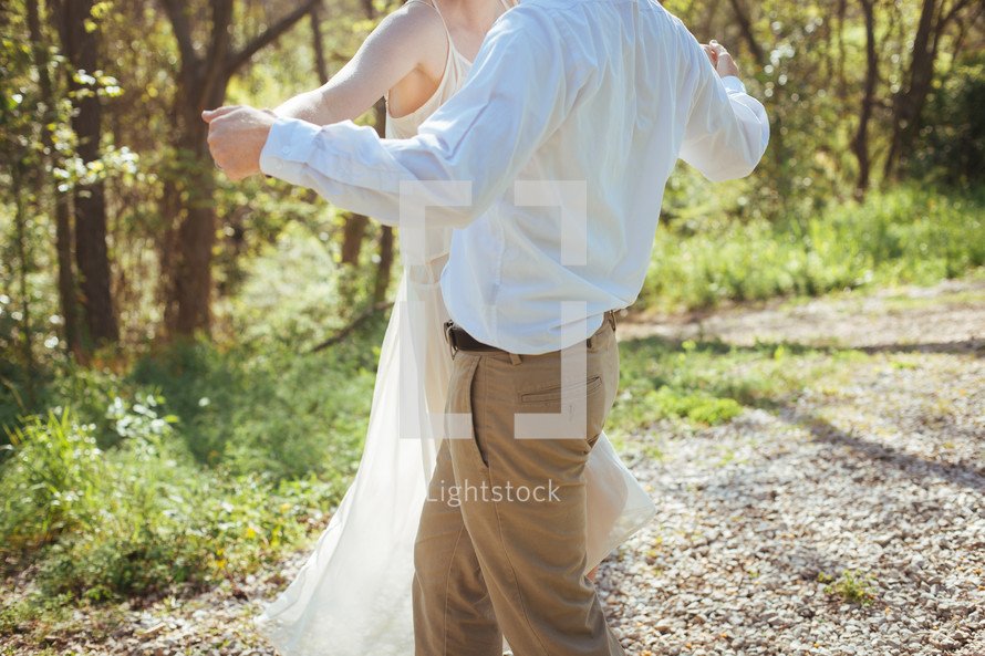 a couple dancing in the woods 