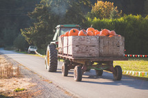 a tractor and wagon of pumpkins 