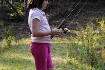 a girl with a fishing pole 