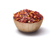 Crushed Red Pepper in a Wooden Bowl on a White Background