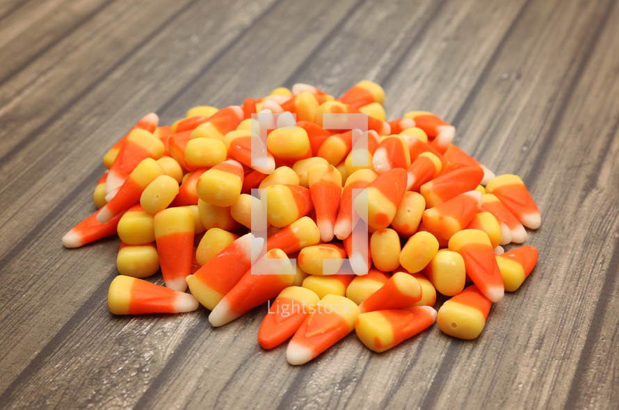 candy corn on wood background 