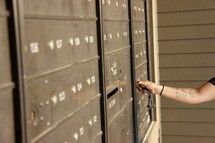 a woman checking her mailbox 